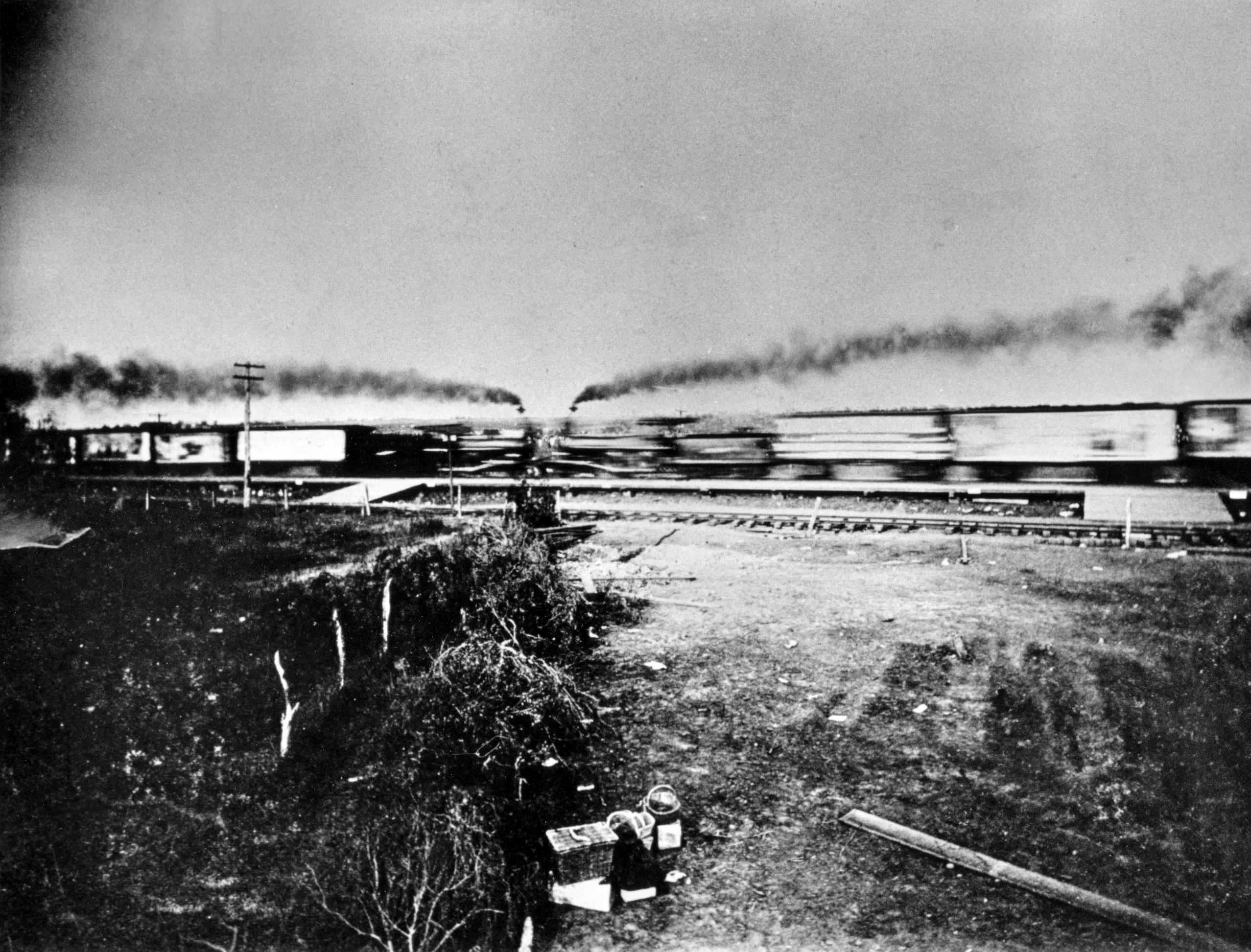 The moment of impact. Two locomotives meet head-on; the photographer was blinded in one eye by a flying bolt seconds after this frame. Crash at Crush, Texas, 1896.